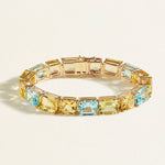 A Closer gold bracelet in 55 carats of lemon quartz, sky blue topaz, and heliodor in bold emerald and cushion cuts, stacked