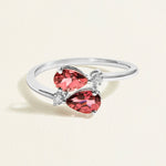 White gold toi et moi ring with red pear tourmalines and diamond accents