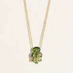 14k Gold chain necklace with green tourmaline gemstones on a light beige background