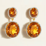 Elegant cocktail earrings in 14 k gold with 24 carats olive quartz ovals in amber orange framed in diamond halo