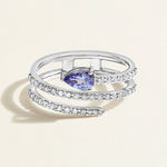 A modern ring in white gold with a spiral of diamonds crowned with a vivid deep blue tanzanite.