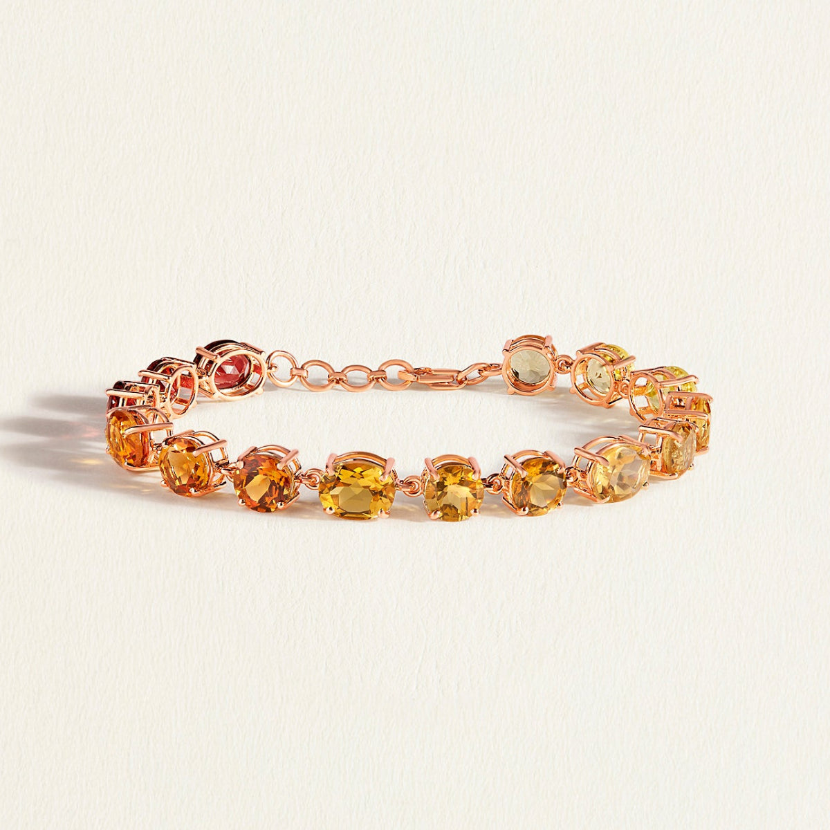 Bracelet with multicolored citrine gemstones on a light beige background