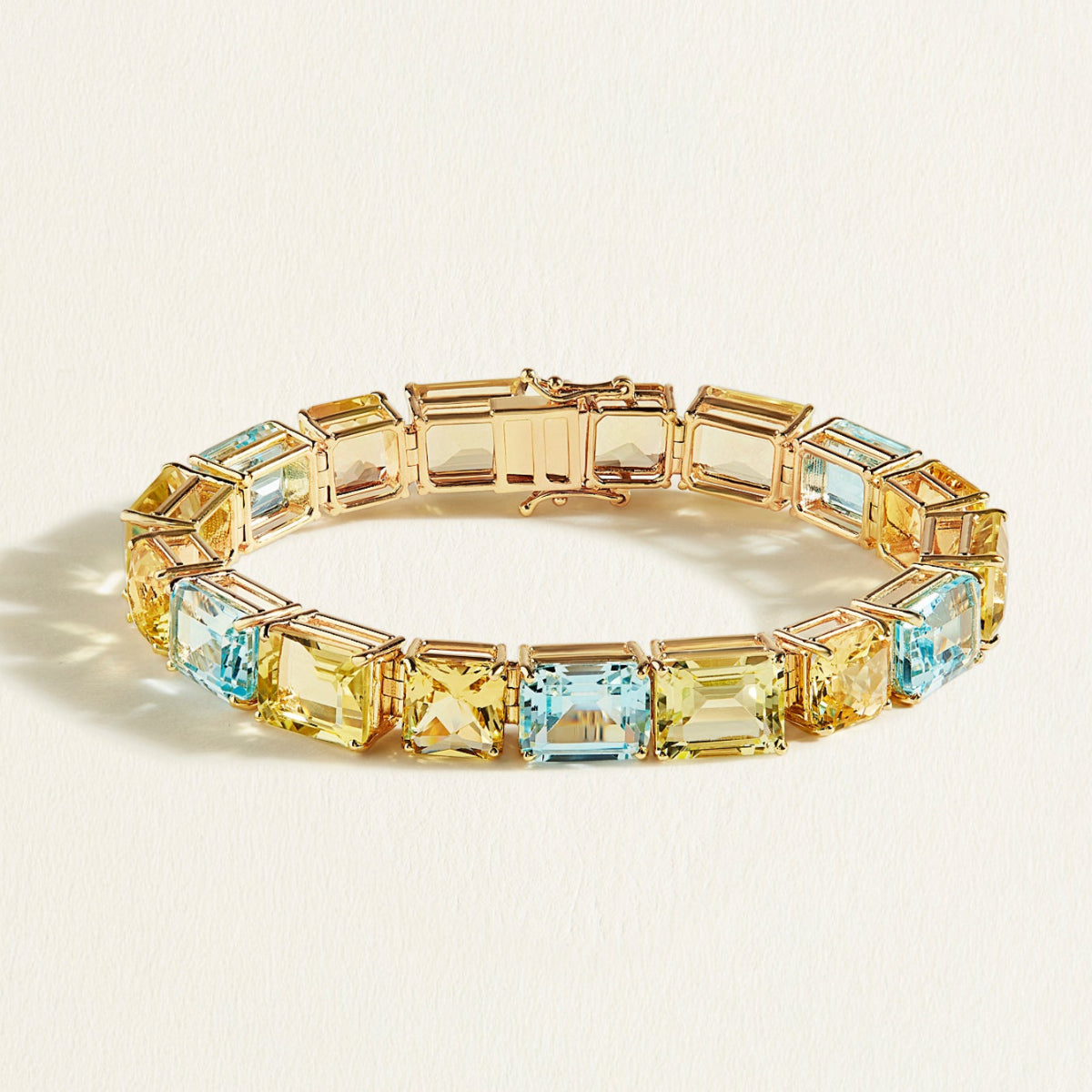 A Closer gold bracelet in 55 carats of  lemon quartz, sky blue topaz, and heliodor in bold emerald and cushion cuts, stacked 