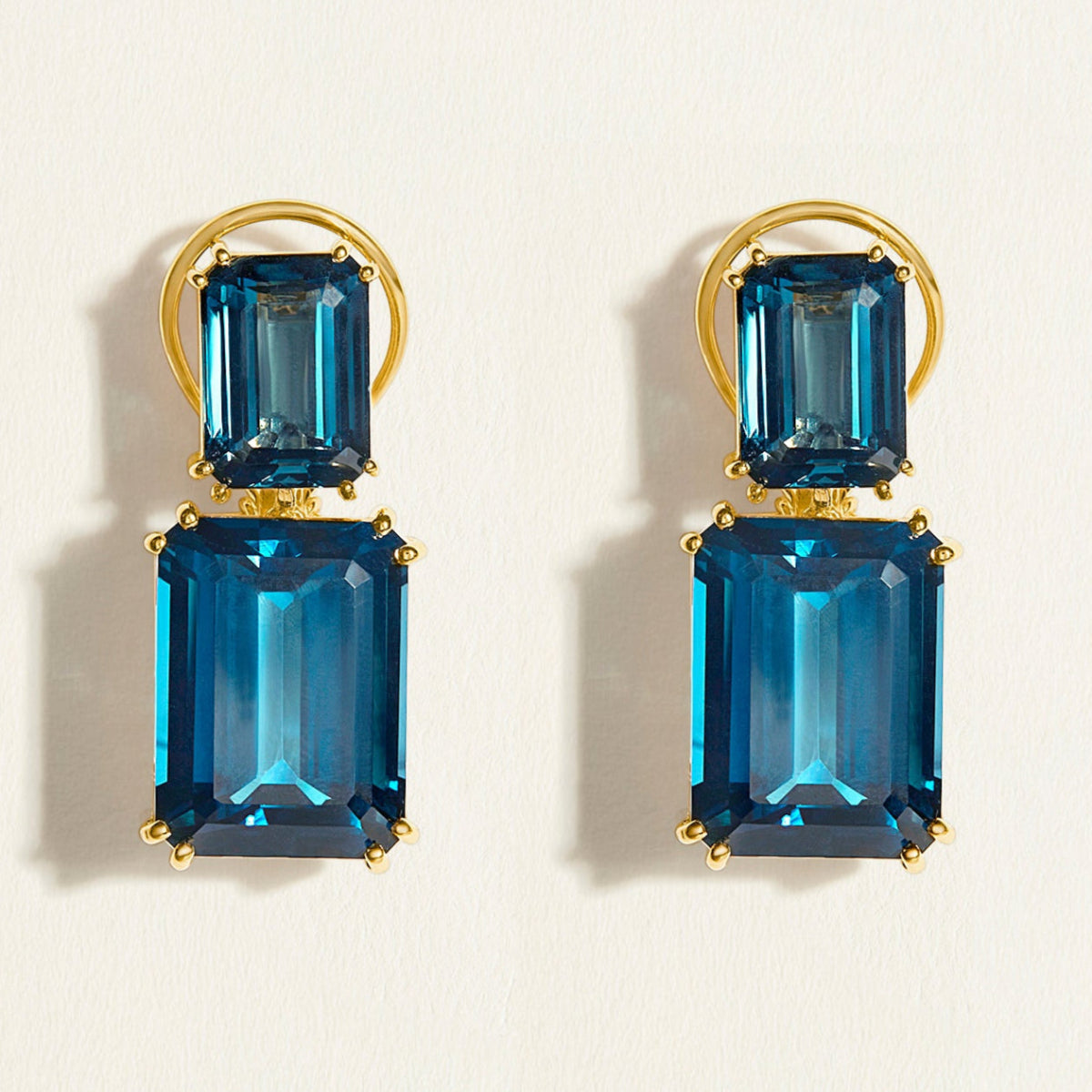 Statement emerald-cut London blue topaz double drops feature in this red carpet cocktail earrings in 14k gold. 