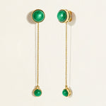 14k Gold chain dangler earrings with green malachite gemstones  on a light beige background