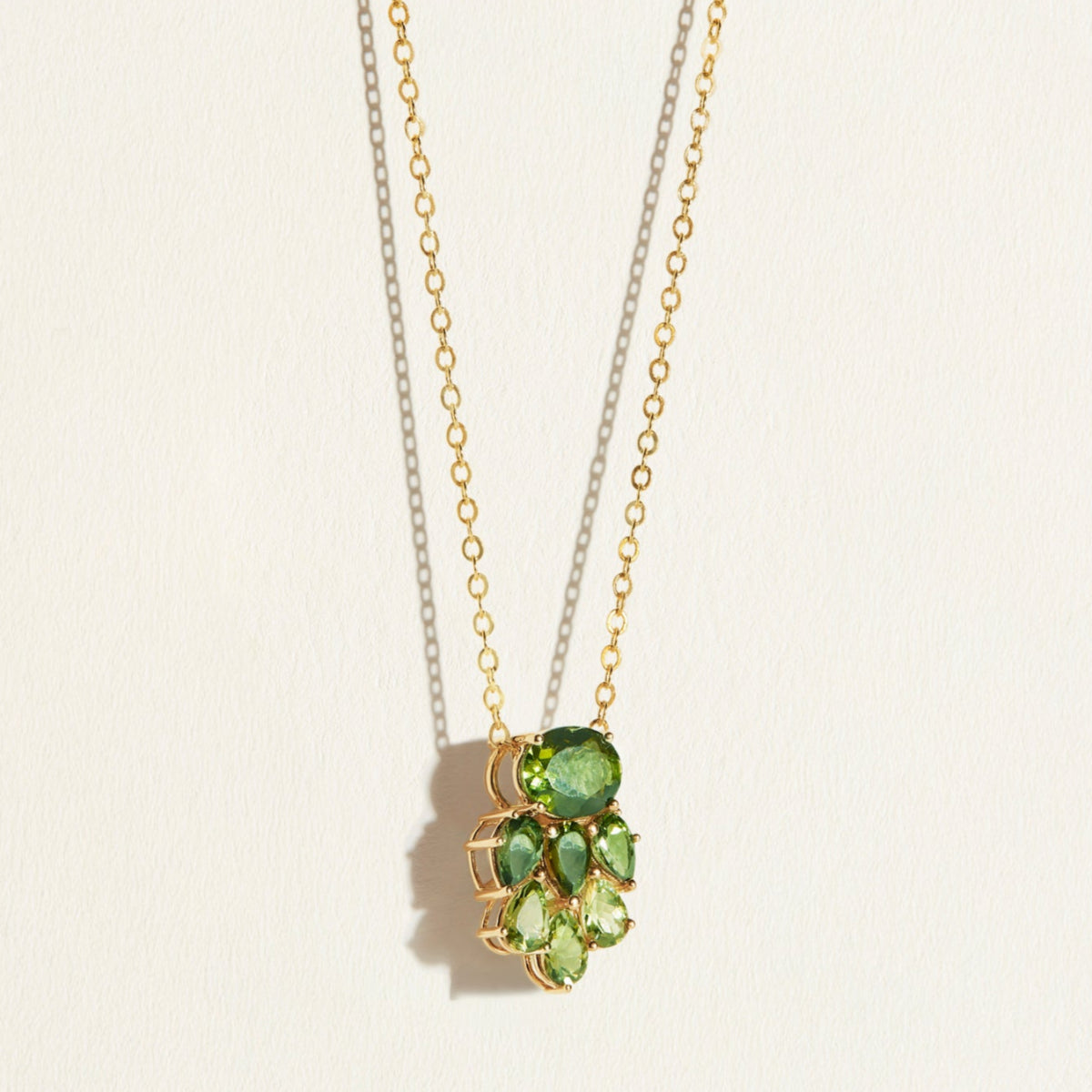 14k 18k Gold necklace with green tourmaline gemstone  cluster pendant on a light background