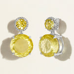 Pair of 18 k white gold lemon quartz yellow gemstone festive earrings with diamond pave on a light beige background