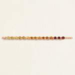 Multicolored citrine gemstone bracelet on a light beige background