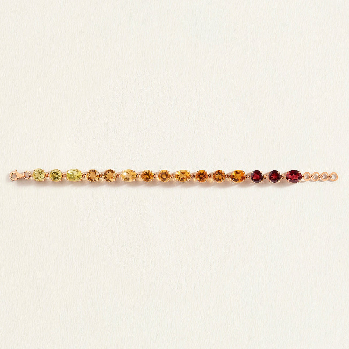 Multicolored citrine gemstone bracelet on a light beige background