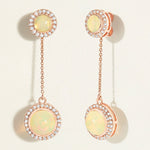 Pair of rose gold 18k earrings with opal stones and rose gold accents with diamond halo on a light background