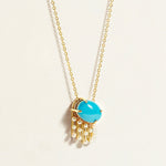 Necklace chain with a turquoise pendant and pearl chain on a light background