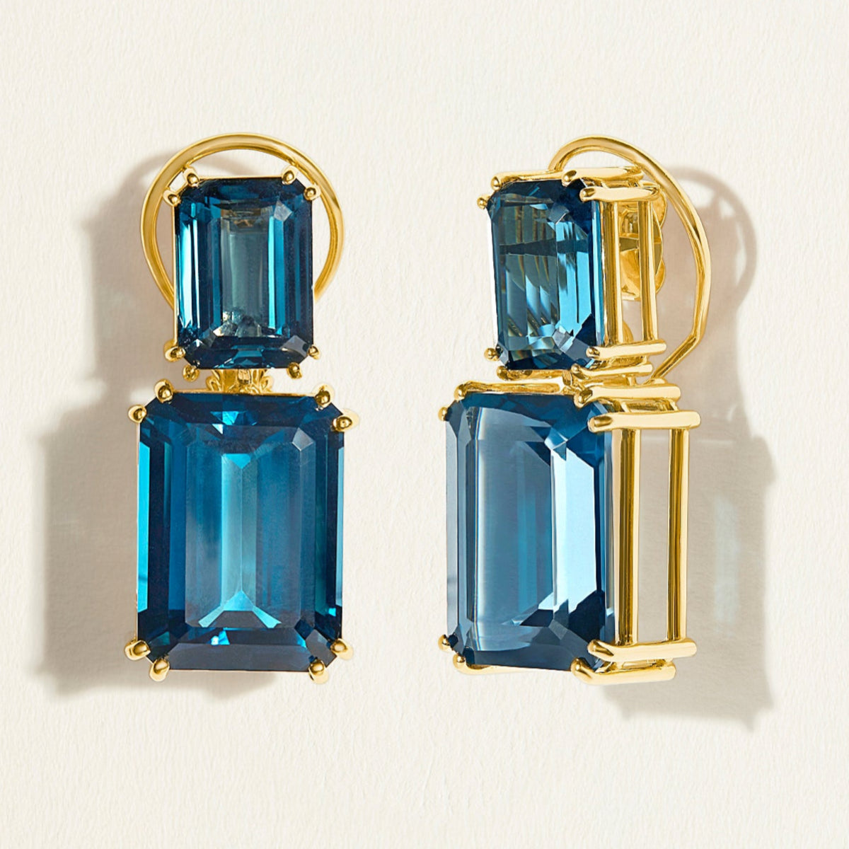 Statement emerald-cut London blue topaz double drops feature in this red carpet cocktail earrings in 14k gold. 