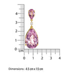 chandelier Purple amethyst teardrop-shaped earrings in 14 k gold  and diamond accents next to a ruler showing their dimensions.