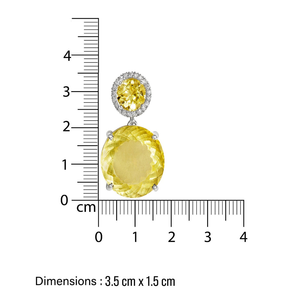 Jewelry festive cocktail earrings with yellow lemon quartz gemstone in 14 k white gold, shown with a ruler for scale on a white background.
