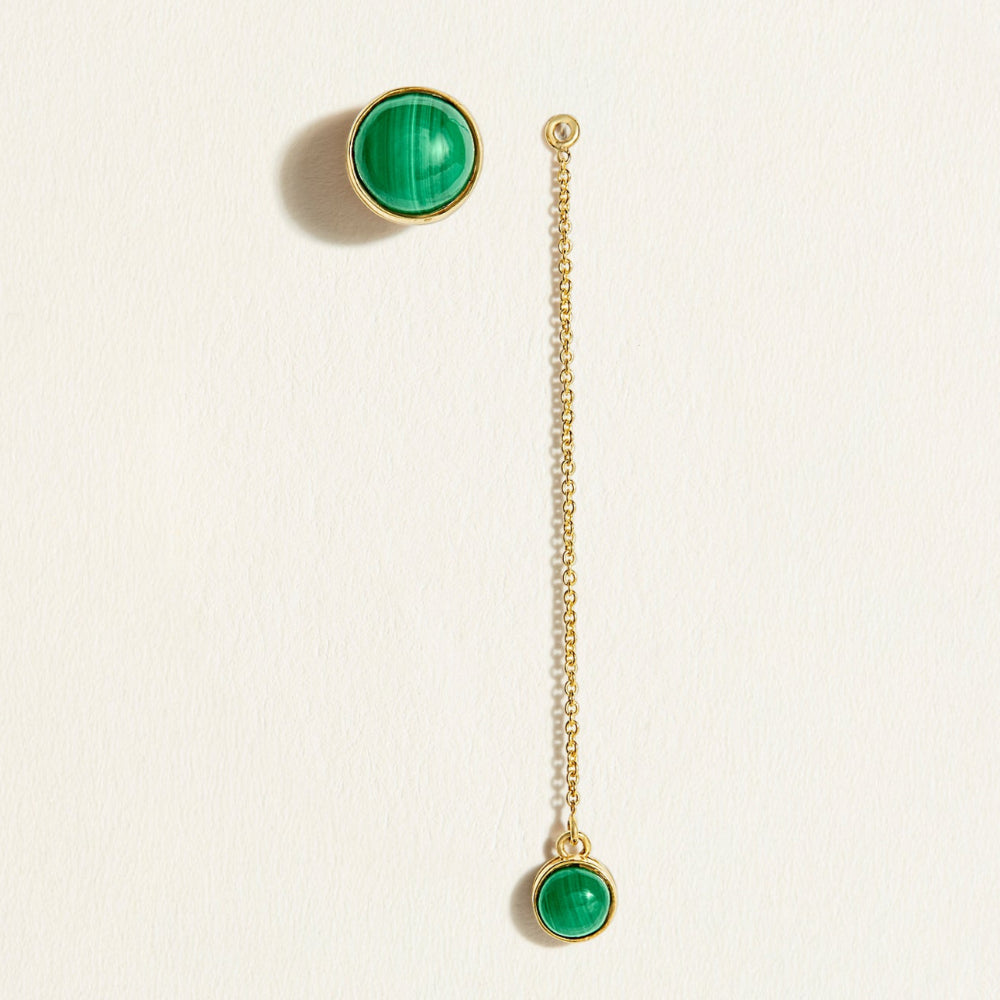 Gold malachite stud earrings with detachable dangler of green malachite gemstones gold chain on a beige background