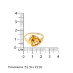 Gold solitare ring with a yellow citrine gemstone next to a ruler showing its dimensions on a white background.