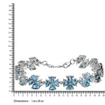 Silver bracelet with blue gemstones next to a ruler for size reference