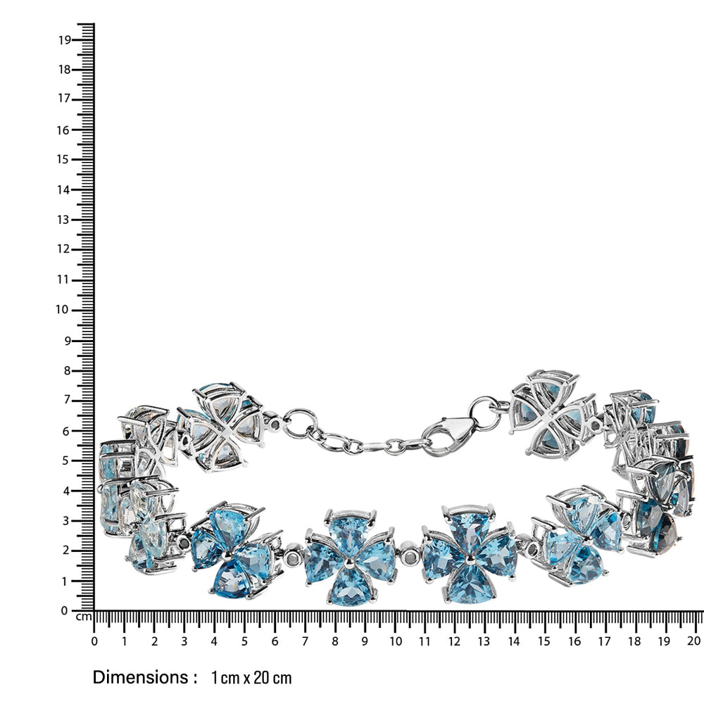 Silver bracelet with blue gemstones next to a ruler for size reference