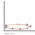 Gold bracelet with blue beads on a white background with a ruler for scale.