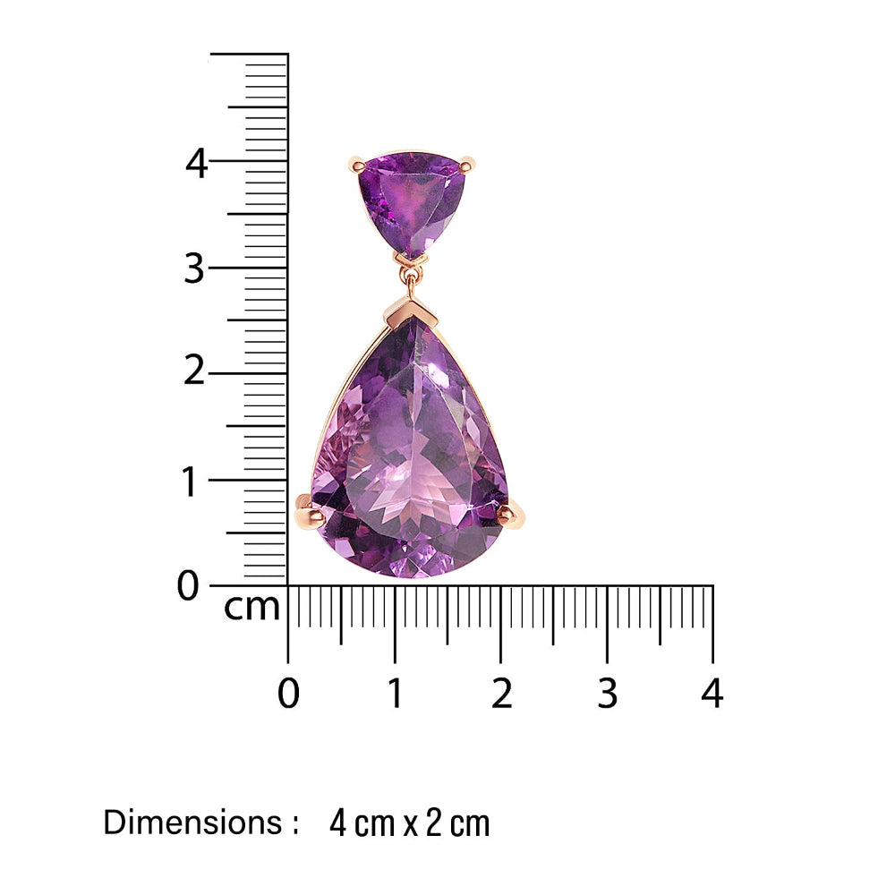 Amethyst large Purple teardrop-shaped cocktail earring with gold setting on a white background, accompanied by a ruler for scale.