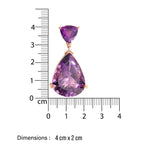 Amethyst large Purple teardrop-shaped cocktail earring with gold setting on a white background, accompanied by a ruler for scale.