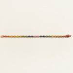 rainbow sapphire gemstone tennis bracelet on a light beige background