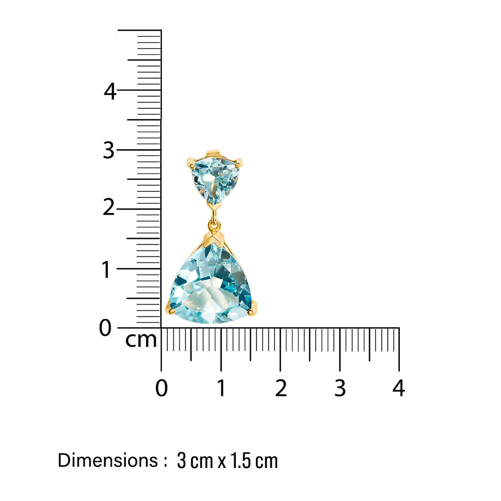 Gold cocktail earring with blue gemstones next to a ruler showing dimensions