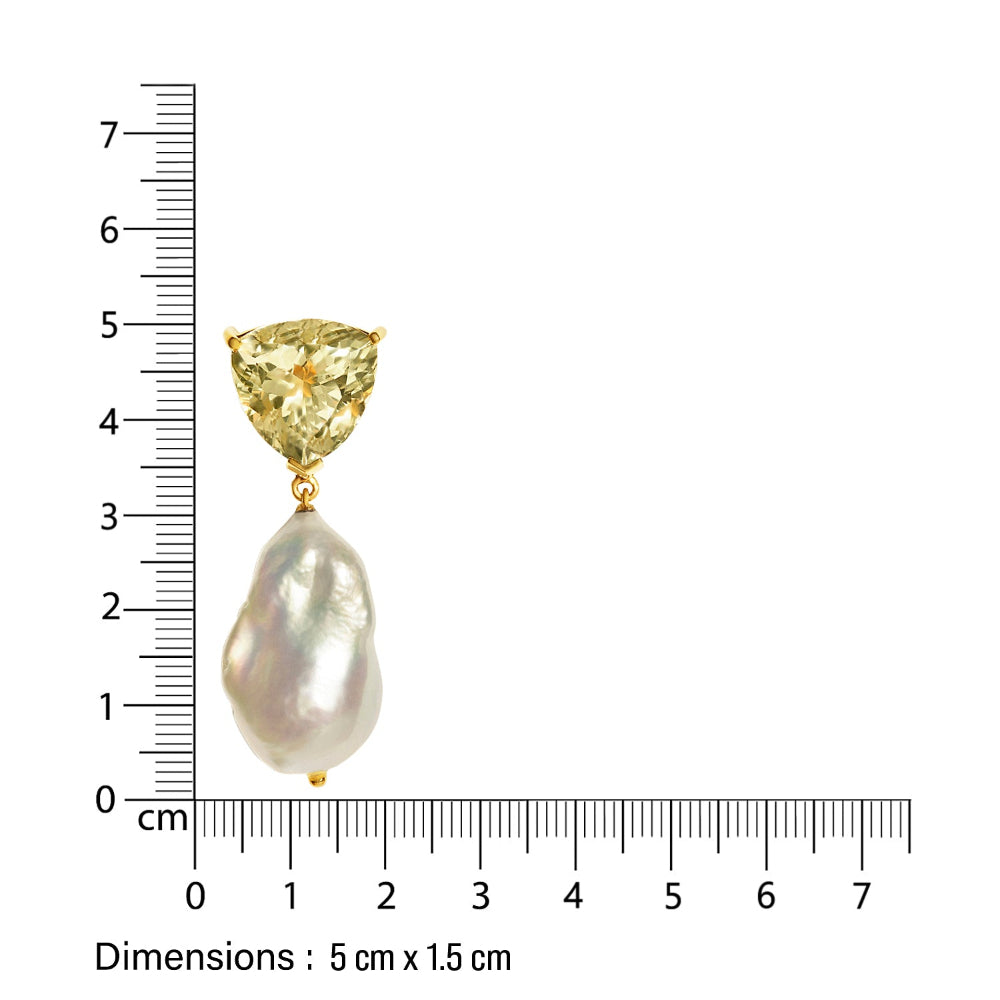 Gold designer earring with a light green  gemstone and baroque pearl, measured against a ruler on a white background.