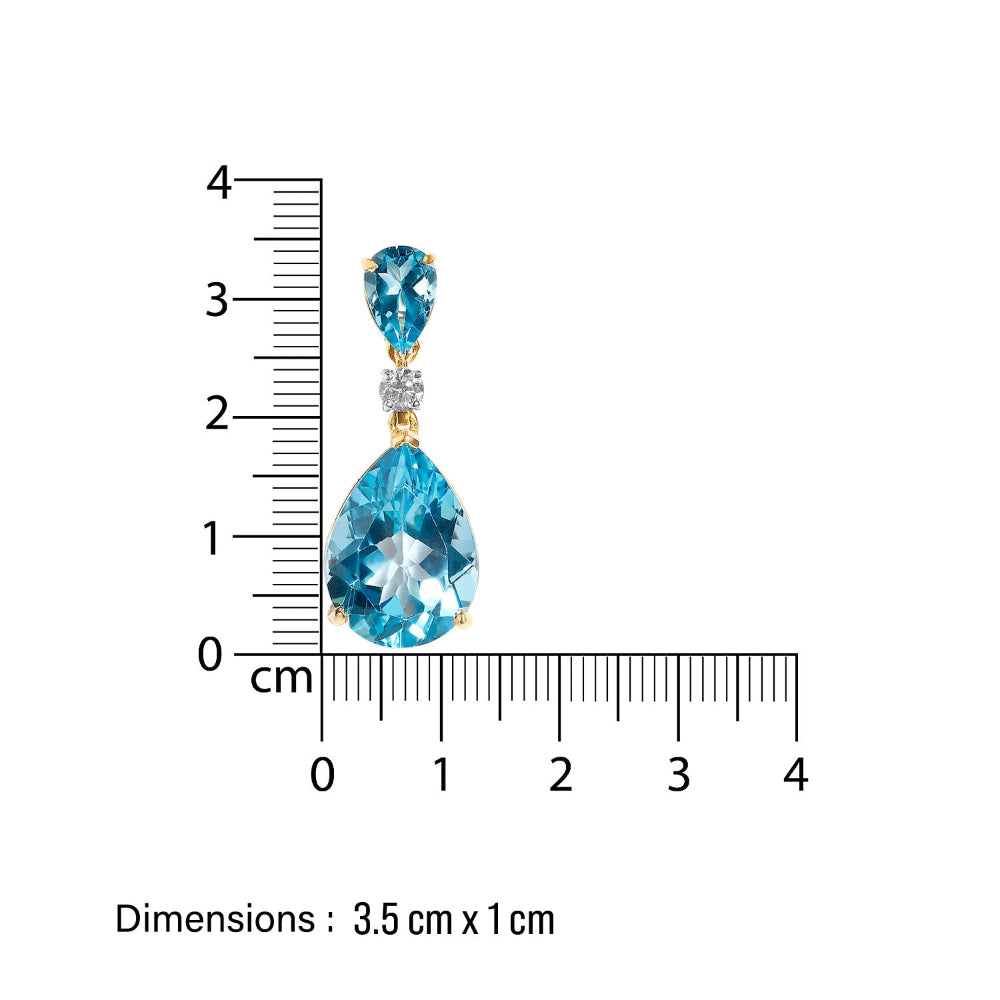 Jewelry earring with blue gemstones and gold accents, shown with a ruler for scale on a white background.