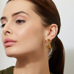 Woman wearing elegant minimal gold earrings with large citrine drops 