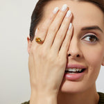 woman wearing a modern gold yellow citrine solitaire bezel  engagement ring 