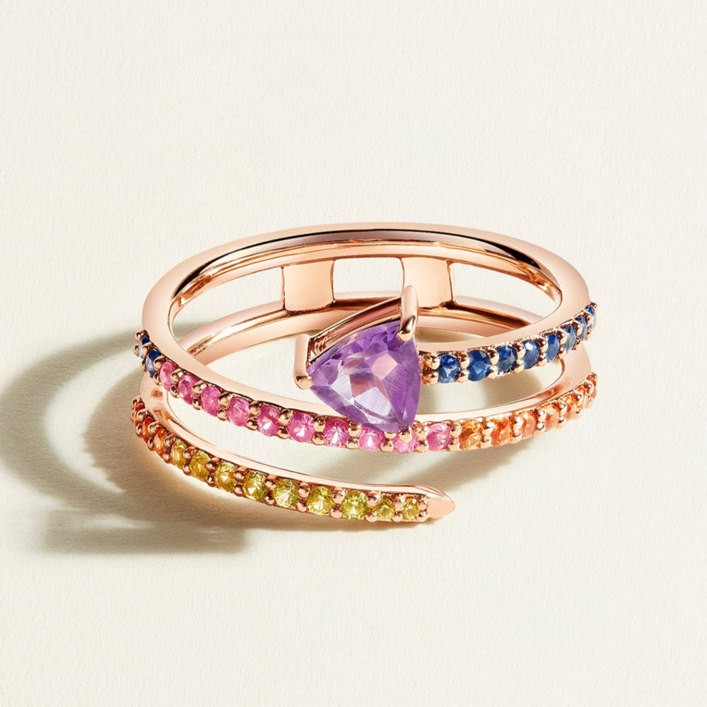 rose gold spiral ring in rainbow sapphires with purple amethyst on top